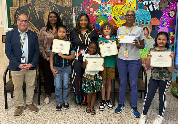 Carver ES students post with art awards