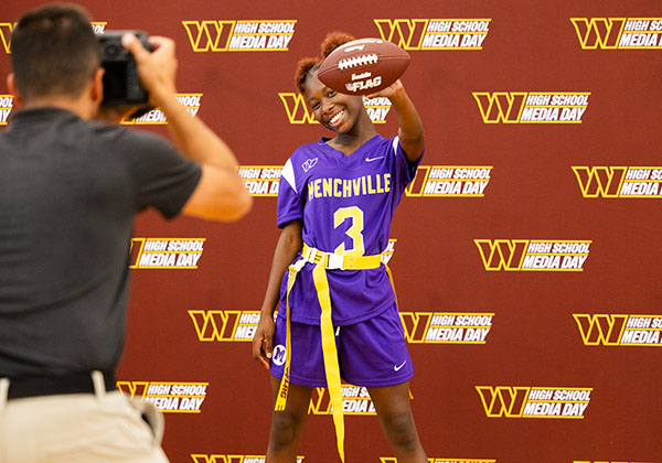 A flag football player being photographed.